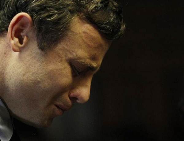 Olympic and Paralympic running star Oscar Pistorius reacts ahead of court proceedings at the Pretoria Magistrates court, August 19, 2013