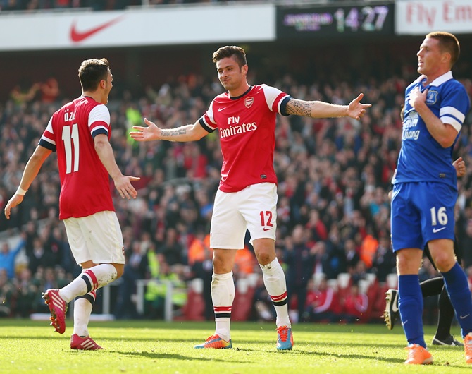 Olivier Giroud of Arsenal celebrates with teammate Mesut Oezil after scoring his team's fourth goal.