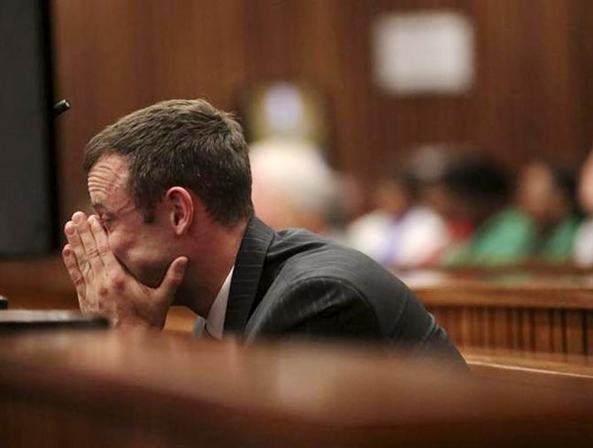 Oscar Pistorius reacts in the dock at the North Gauteng High Court in Pretoria