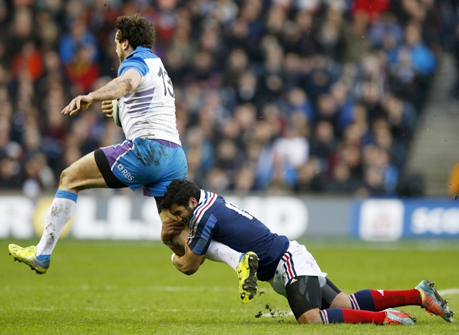Alex Dunbar is tackled by France's Maxime Mermoz