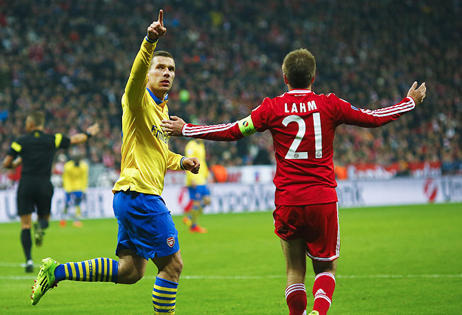 Arsenal's Lukas Podolski (left) celebrates after scoring against Bayern Munichon Tuesday