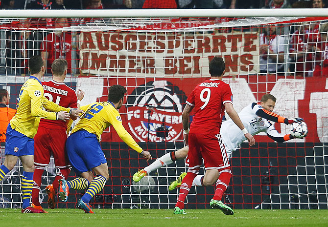 Bayern Munich's Manuel Neuer (right) saves a shot by Arsenal's Oliver Giroud on Tuesday