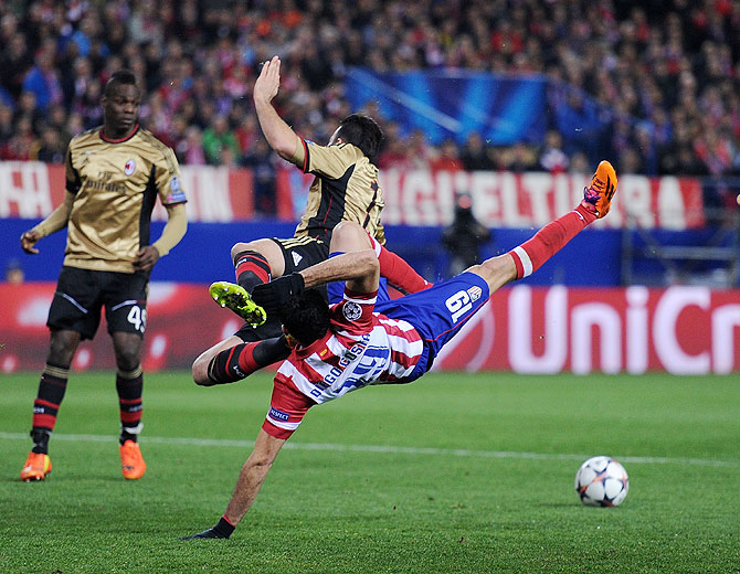 Diego Costa (right) of Atletico Madrid clashes with Adil Rami of AC Milan during their match on Tuesday