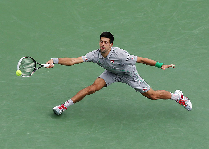Novak Djokovic of Serbia lunges to play a return against Alejandro Gonzalez of Colombia at Indian Wells Tennis Garden on Tuesday