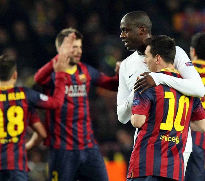 Barcelona's Lionel Messi, right, is embraced by Manchester City's Yaya Toure after their Champions League last 16 second leg match