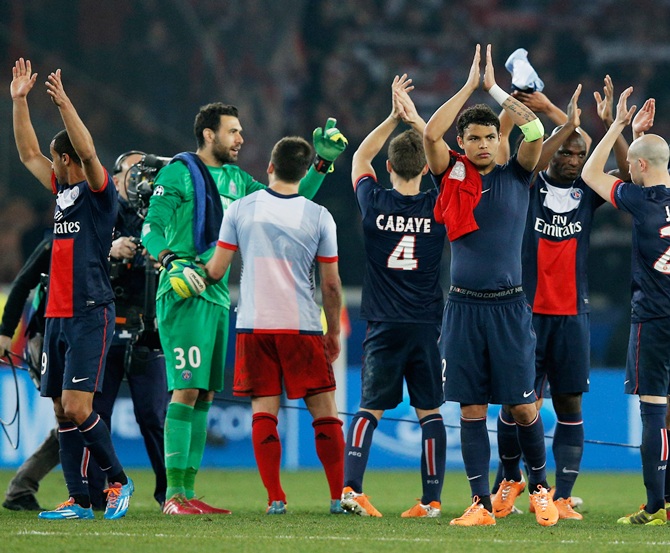 PSG players celebrate victory after the UEFA Champions League Round of 16 second leg match against Bayer Leverkusen