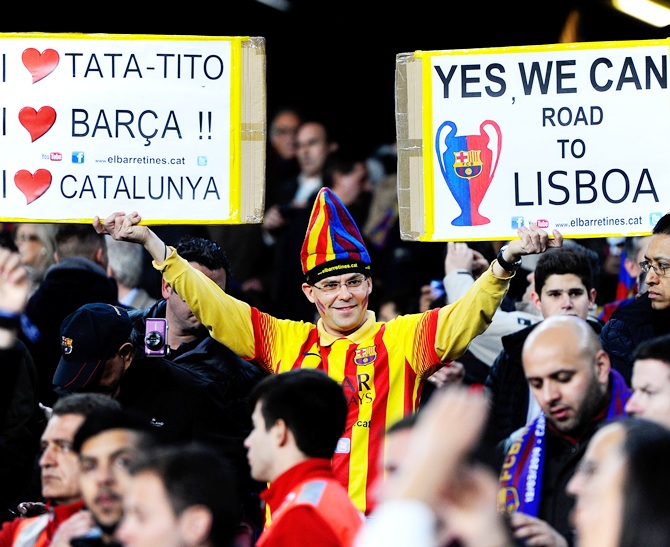 A Barcelona fan cheers on his team during the UEFA Champions League match