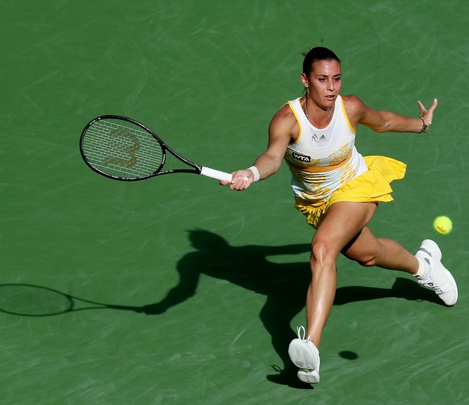 Flavia Pennetta of Italy hits a return to Sloane Stephens
