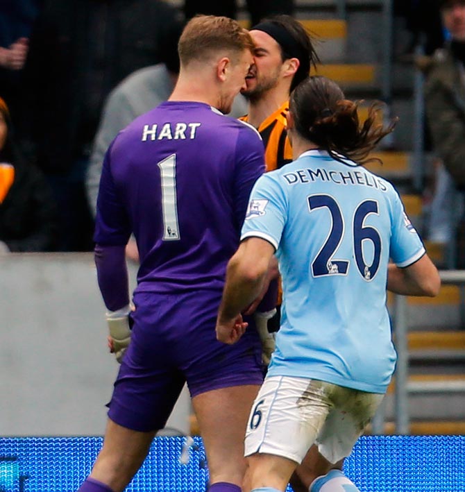 Manchester City goalkeeper Joe Hart (left) clashes with Hull City's George Boyd