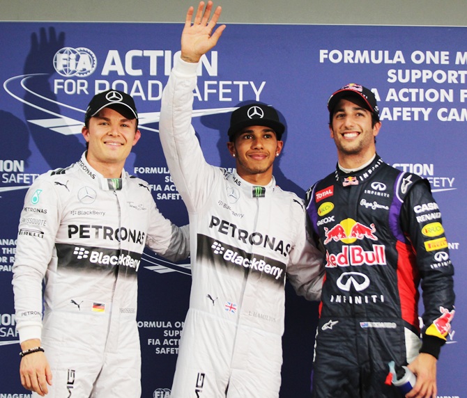 Lewis Hamilton, centre, of Mercedes GP celebrates finishing first alongside second placed Daniel   Ricciardo, right, of Infiniti Red Bull and third placed Nico Rosberg of Mercedes GP