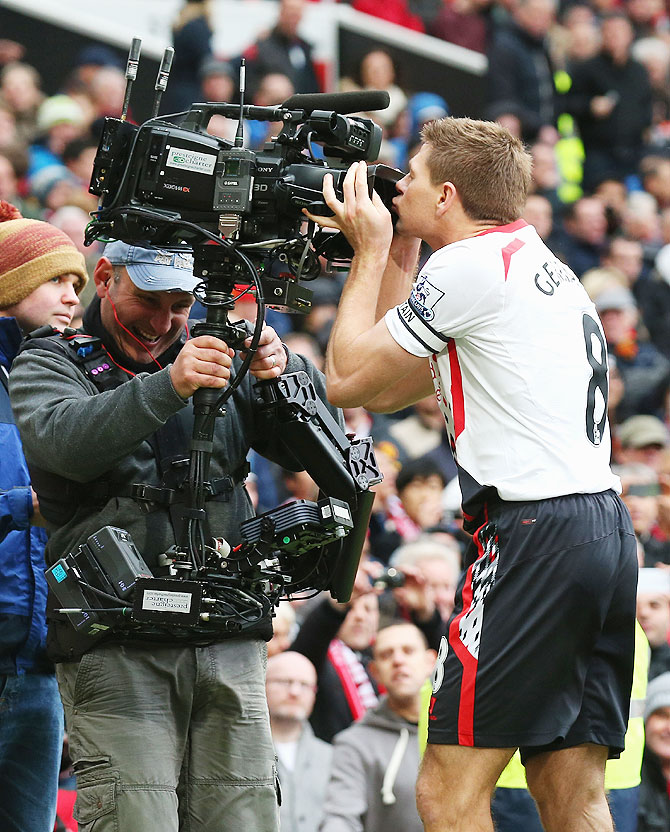 Steven Gerrard of Liverpool kisses the steadicam as he celebrtaes scoring the second goal against Manchester United during their English Premier League match at Old Trafford on Sunday