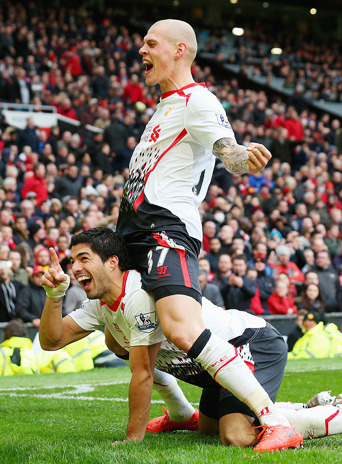 Luis Suarez of Liverpool celebrates with Martin Skrtel after scoring against Manchester United on Sunday