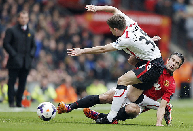 Manchester United's Robin van Persie (right) challenges Liverpool's Jon Flanagan on Sunday