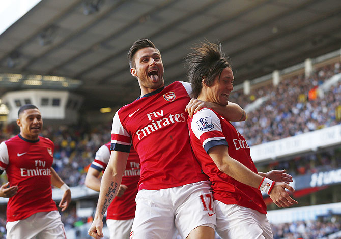 Arsenal's Tomas Rosicky (right) celebrates his goal against Tottenham Hotspur with Olivier Giroud on Sunday