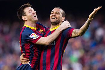 FC Barcelona's Lionel Messi celebrates with teammate Daniel Alves after scoring against Osasuna during their La Liga match on Sunday