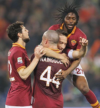 Francesco Totti (centre) of AS Roma celebrates with his teammates after scoring on Monday