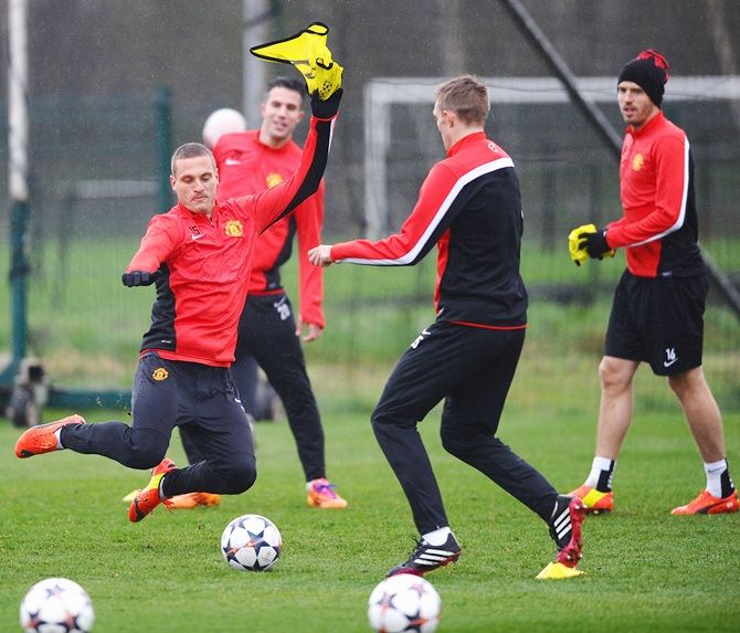 Manchester United's Nemanja Vidic in action during a training session with Paul Scholes, Michael Carrick