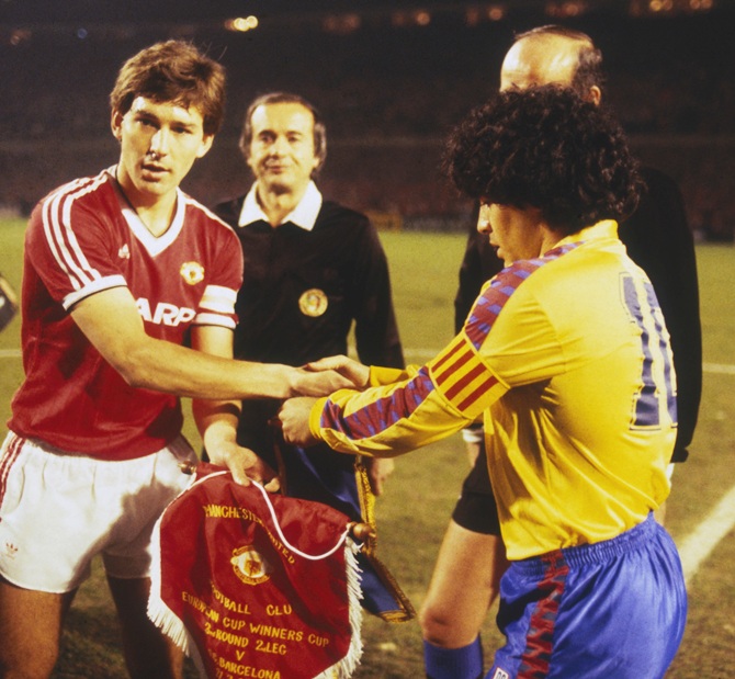 Captain Bryan Robson (left) of Manchester United shakes hands with Barcelona captain Diego Maradona before the   European Cup Winners Cup Quarter-Final Second Leg match between Manchester United and Barcelona held on March 21, 1984 at Old Trafford, in Manchester