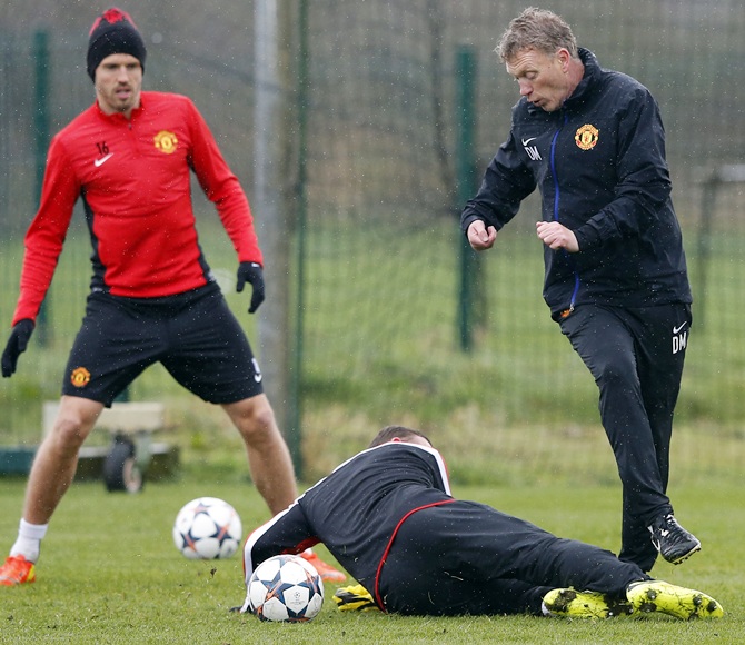 Manchester United's manager David Moyes, right, is challenged by Wayne Rooney