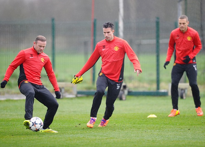 Wayne Rooney and Robin Van Persie of Manchester United in action during a training session