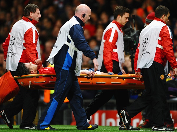 Robin van Persie of Manchester United is stretchered off