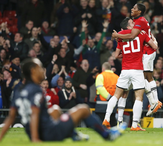 Manchester United's Antonio Valencia, right, and Robin van Persie celebrate