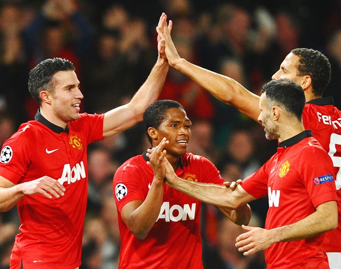 Robin van Persie of Manchester United celebrates scoring the goal with his team-mates