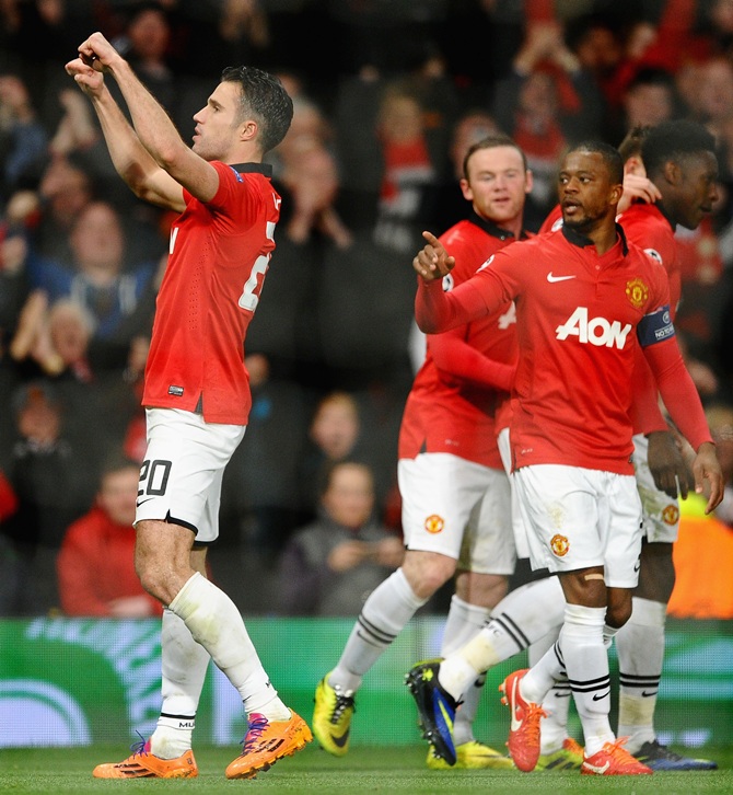 Robin van Persie of Manchester United celebrates scoring the goal against Olympiacos FC at Old Trafford