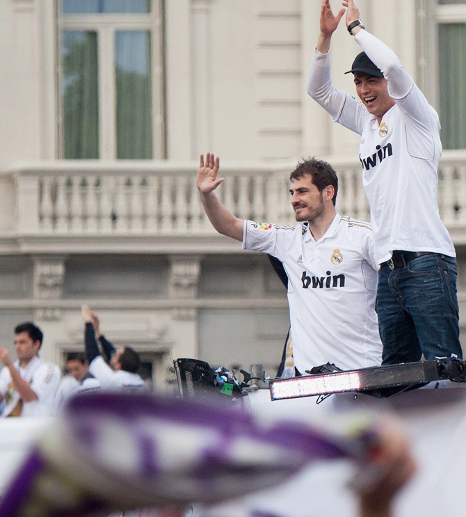 Real Madrid's goalkeeper Iker Casillas, left, and Cristiano Ronaldo celebrate with supporters