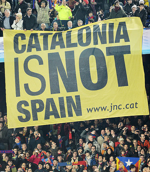 Barcelona supporters hold up a banner reading 'Catalunya is not Spain'