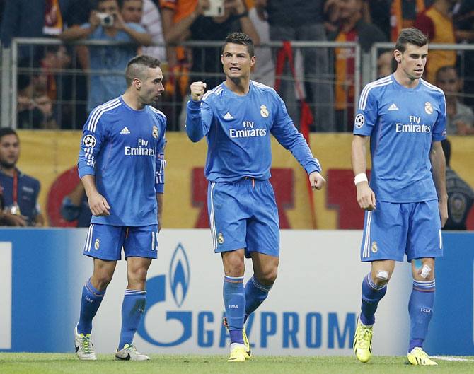 Real Madrid's Cristiano Ronaldo, centre with teammates Daniel Carvajal,left, and Gareth Bale