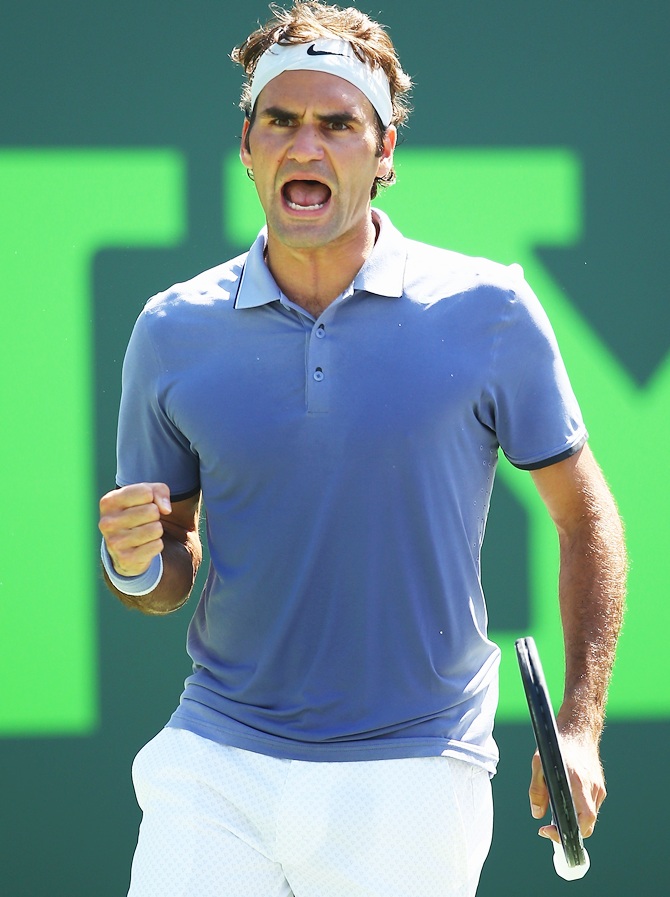 Roger Federer of Switzerland celebrates match point against Ivo Carlovic of Croatia