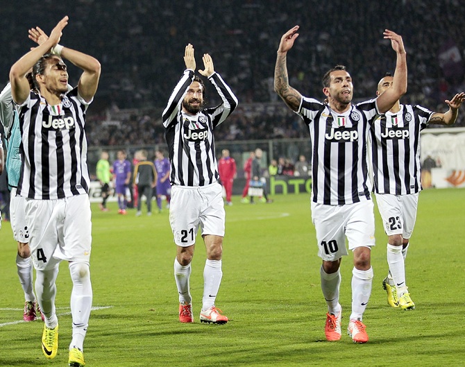 Juventus players celebrate after Carlos Tevez (right) scored against Catania