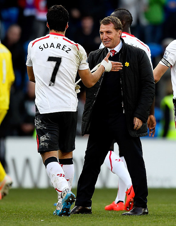 Luis Suarez of Liverpool is congratulated by his manager Brendan Rogers after their match against Cardiff City on Saturday