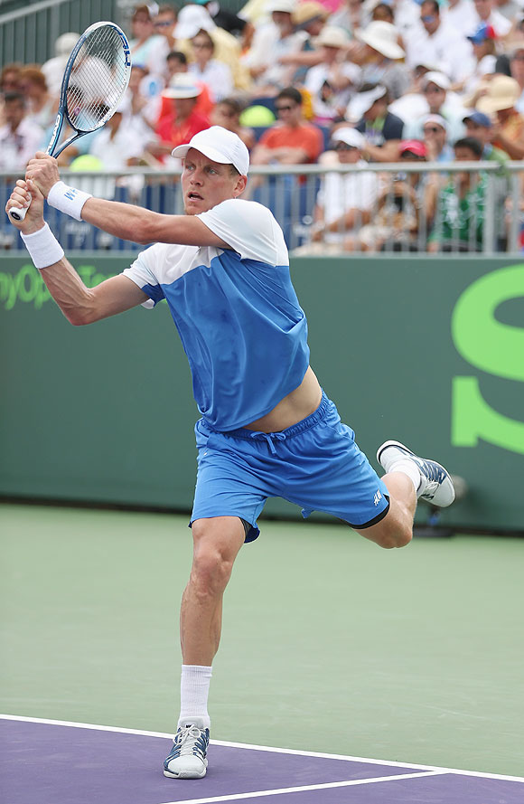 Tomas Berdych of the Czech Republic plays a backhand against Stephane Robert of France