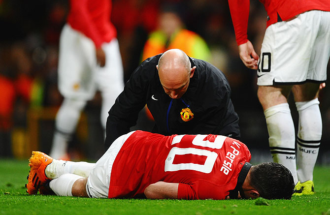 Robin van Persie of Manchester United receives treatment during the UEFA Champions League Round of 16 second round match against Olympiacos FC at Old Trafford 
