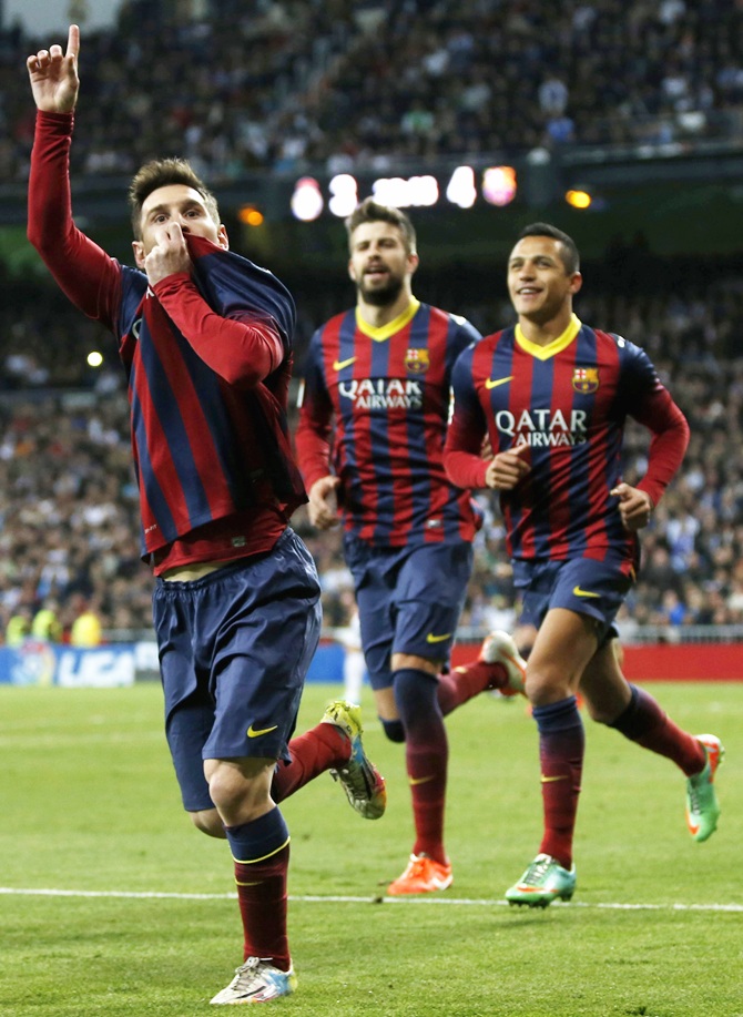From left, Barcelona's Lionel Messi, Gerard Pique and Alexis Sanchez celebrate