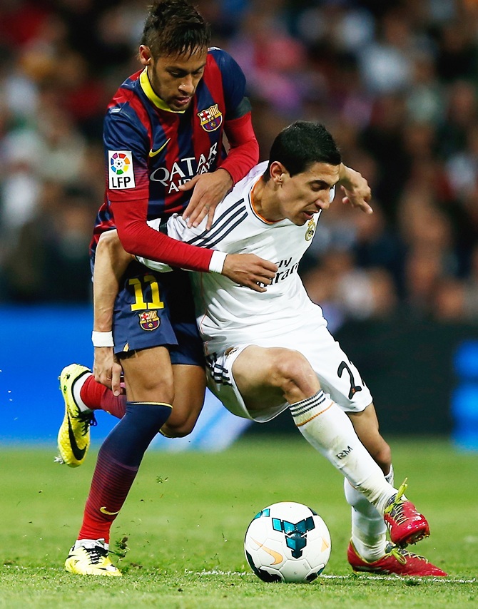 Angel Di Maria of Real Madrid is challenged by Neymar of Barcelona