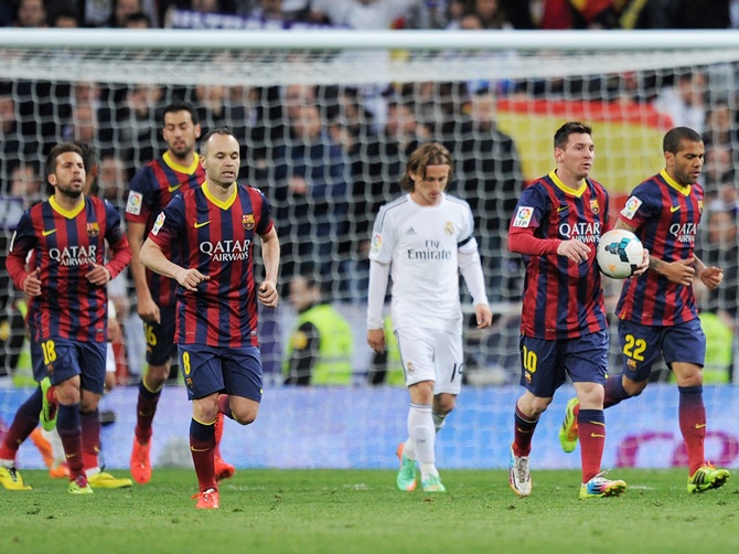 Lionel Messi of Barcelona runs the ball back to the centre spot after his first goal