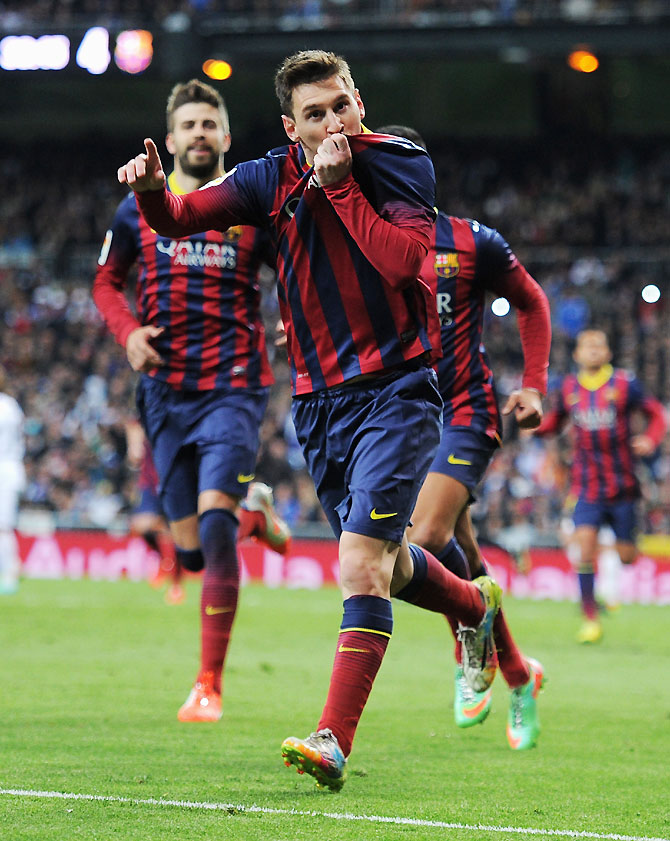 Lionel Messi of Barcelona celebrates scoring his team's fourth goal during their La Liga match against Real Madrid at the Bernabeu in Madrid on Sunday