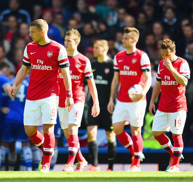 A dejected Lukas Podolski of Arsenal looks on