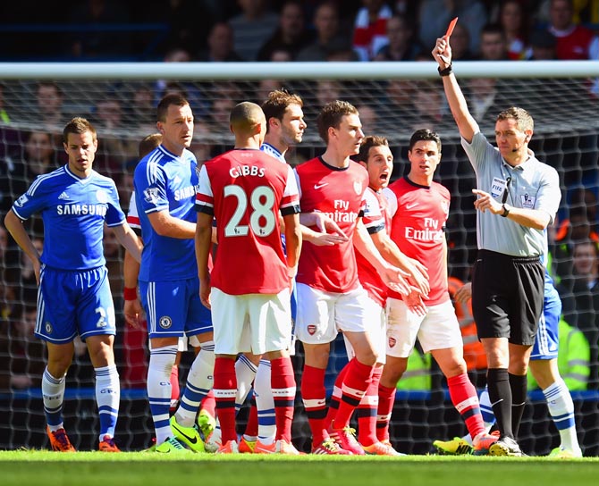 Referee Andre Marriner shows Kieran Gibbs of Arsenal a red card