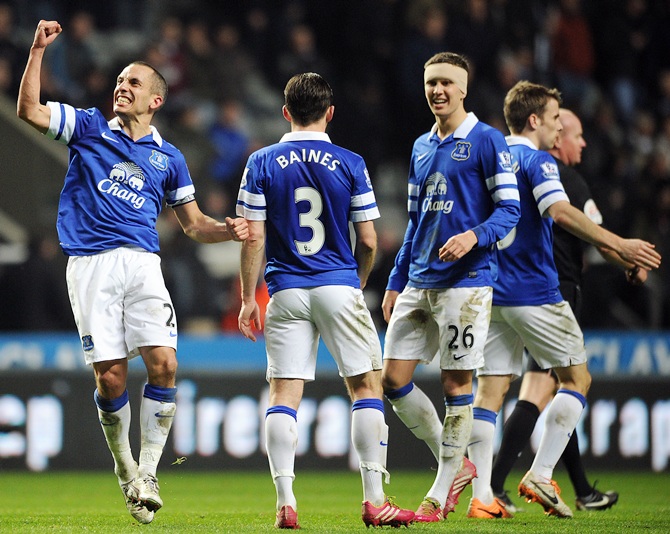 Leon Osman,left, of Everton celebrates scoring his side's third goal