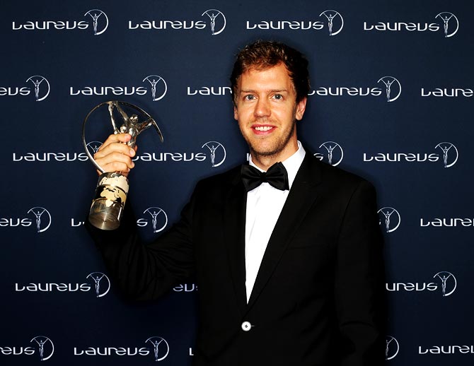 Sebastian Vettel poses with the trophy after winning the Laureus World Sportsman of the Year award