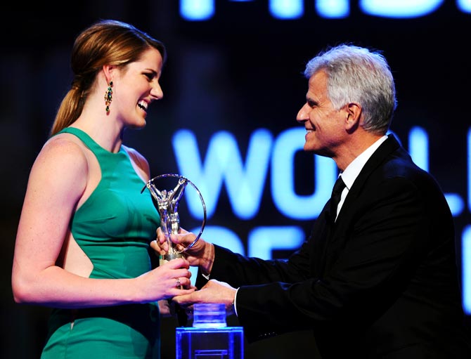 Missy Franklin receives her Laureus World Sportswoman of the Year award from Laureus Academy Member Mark Spitz