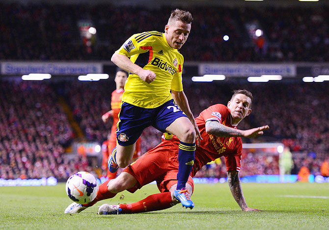 Daniel Agger of Liverpool challenges Emanuele Giaccherini of Sunderland during their match on Wednesday