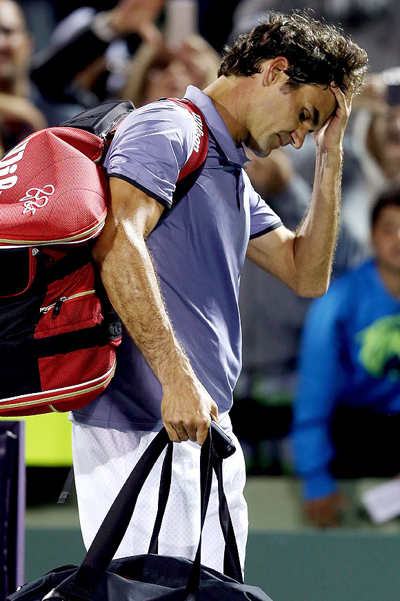 Roger Federer of Switzerland leaves the court after losing to Kei Nishikori of Japan during the Miami Master, Sony Open at the Crandon Park Tennis Center on Wednesday