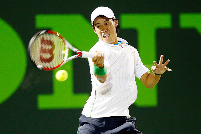 Kei Nishikori hits a forehand against Roger Federer on Wednesday