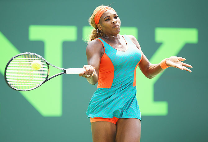 Serena Williams returns a shot against Maria Sharapova on Thursday