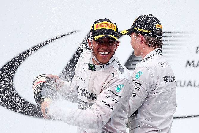 Race winner Lewis Hamilton and Mercedes GP (left) celebrates on the podium with teammate and second placed Nico Rosberg after the Malaysia Formula One Grand Prix at the Sepang Circuit in Kuala Lumpur on Sunday